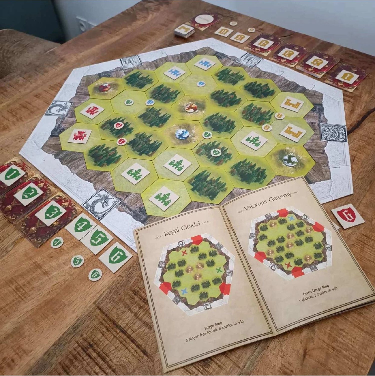 The Book of Maps open next to the board