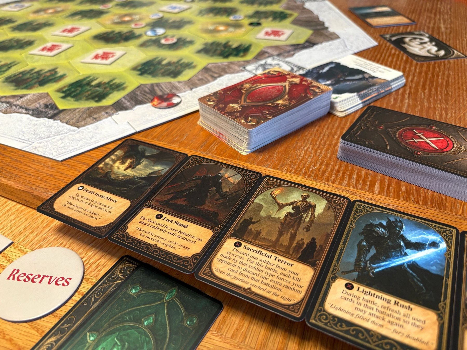 Dragon Soul cards, tokens and the board on a wooden table